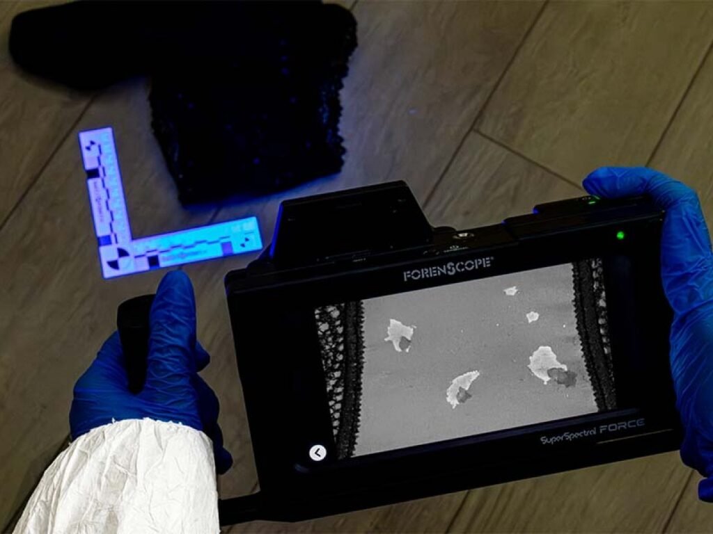 Forensic professional utilizing the SuperSpectral FORCE system for high-speed spectral imaging of biological evidence and complex fingerprint patterns.