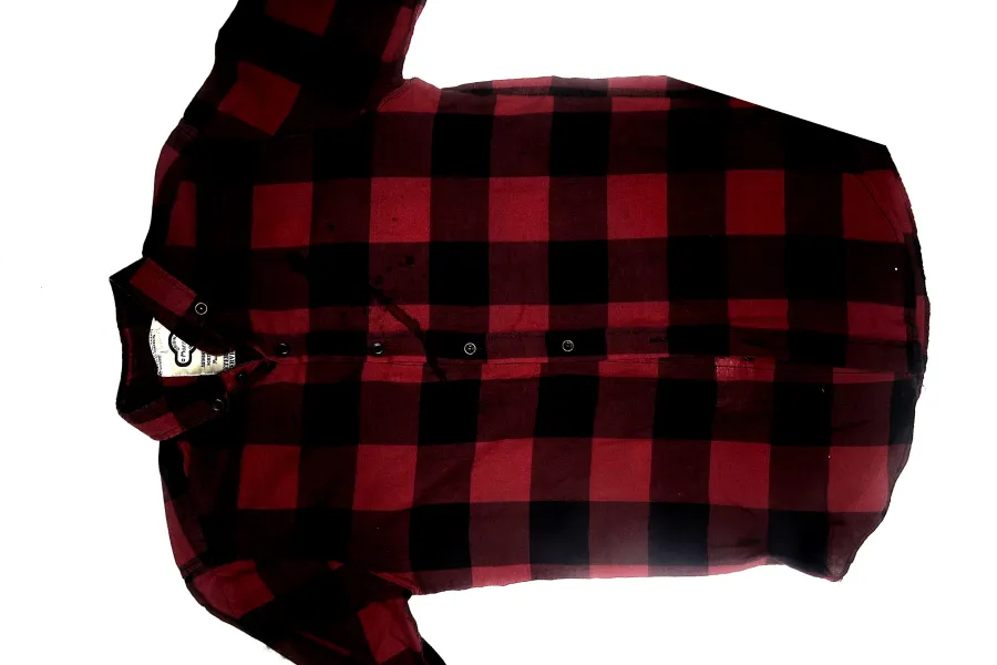 Naked-eye view of a red and black checkered shirt examined for blood stains during forensic investigation.