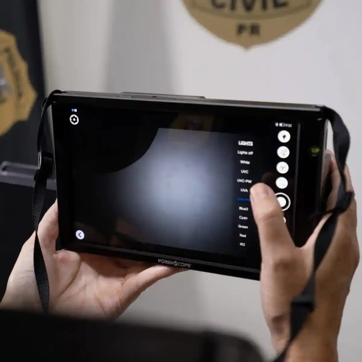 A forensic specialist uses the ForenScope 8K Android Latent Fingerprint Detection Tablet during a crime scene examination in Paraná, Brazil.